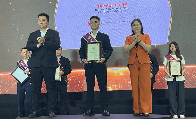 GAP Global team celebrating achievements on stage
